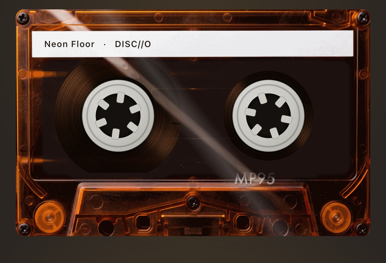 AMBER cassette shell: orange transparent plastic with the tape pack visible