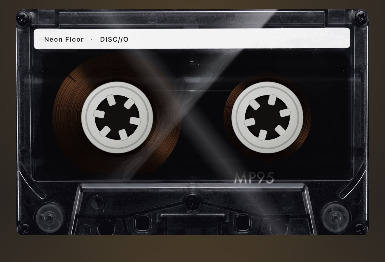 NOIR cassette shell: smoked black plastic, one diagonal highlight, tape and hubs visible behind the window
